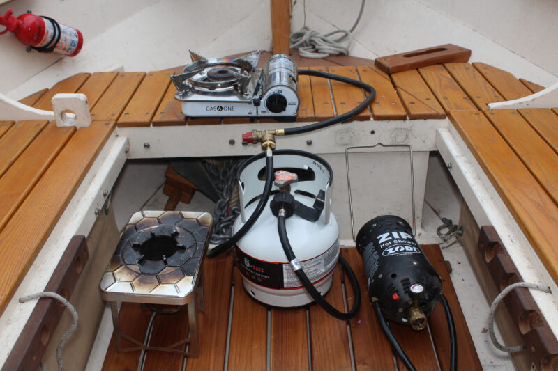 Gas Growler tank with two stoves and portable shower.