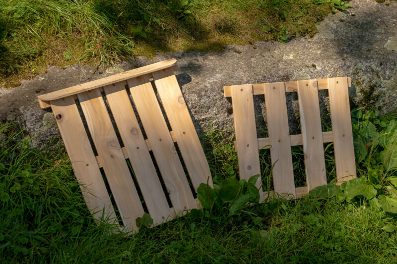 Two sectional-floorboards displayed against granite ledge.
