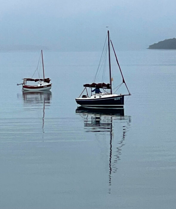 A Scamp and a Cygnet 20 anchored in Ralphs Bay, Tasmania, at dawn.