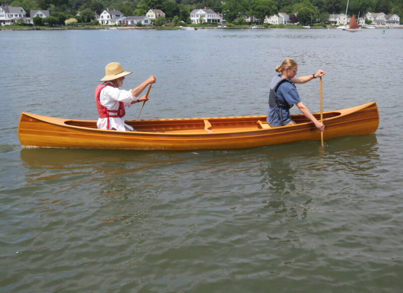 Two men paddling the Newfound Woodworks Chestnut Kruger canoe