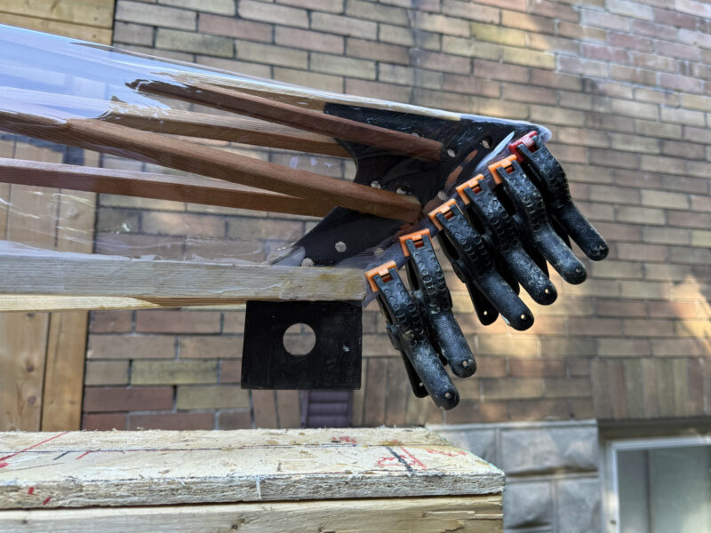 Skin being clamped to frame of Urban Boat kayak