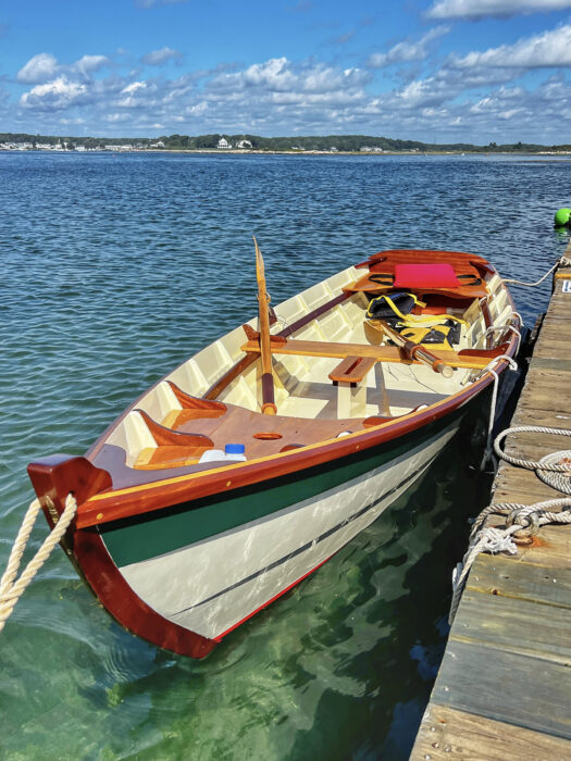 A 14' Heidi skiff alongside a wooden dock.