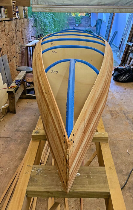 Puddle Duck canoe being strip planked on strongback and molds.
