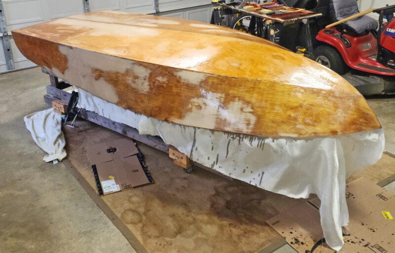 Sheathing a Glen-L Squirt with fiberglass cloth and epoxy.