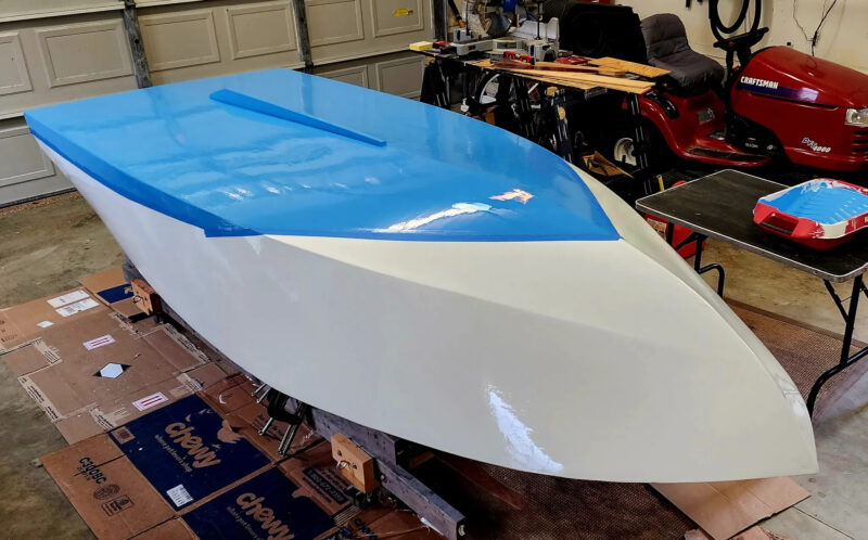 Painting the hull of a plywood runabout.