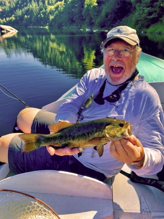 Man with smallmouth bass before releasing.