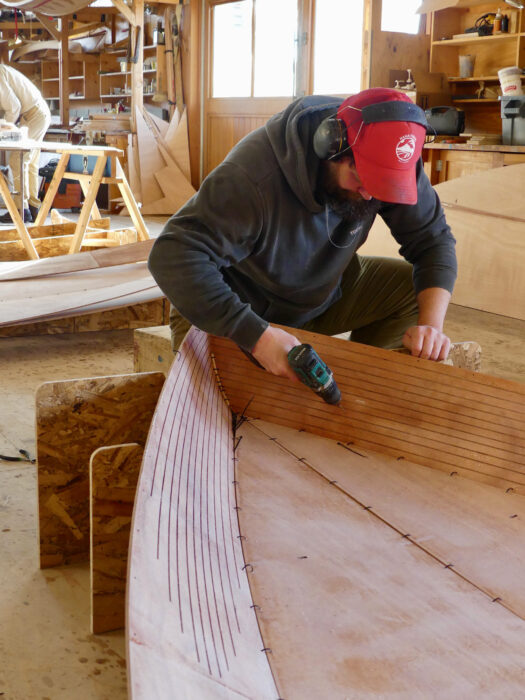 Assembling the garboard panels at the bow of an Old Salt 15.
