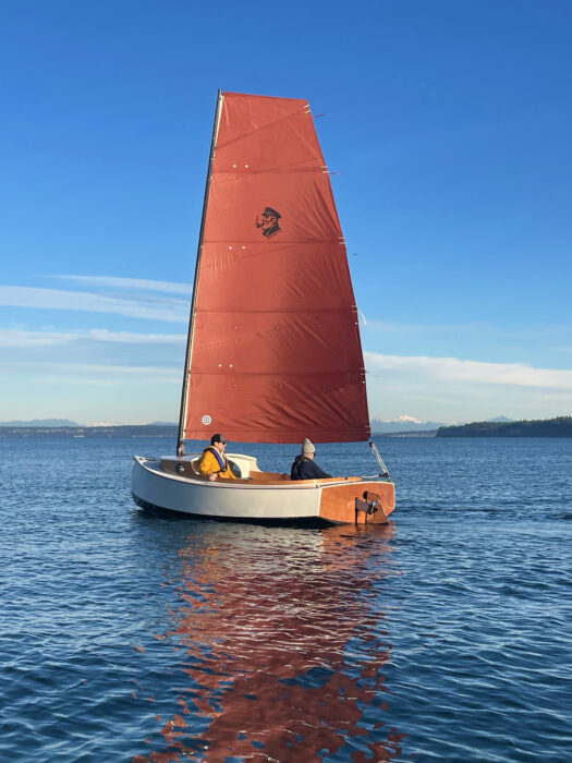 Old Salt 15 reaching under full sail on a calm day.