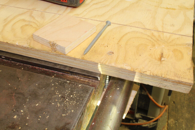 Screwing down a plywood table saw base.