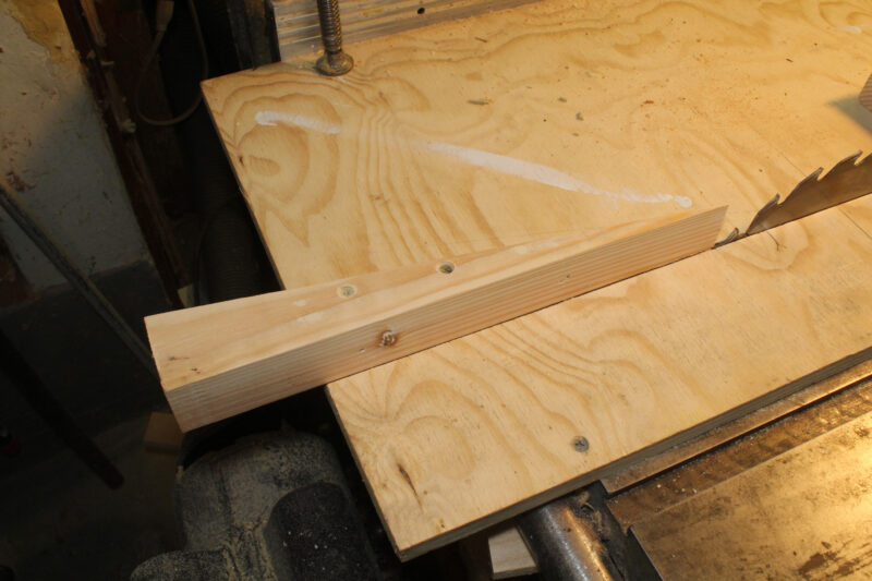 Setting up an outfeed fence on a table saw.
