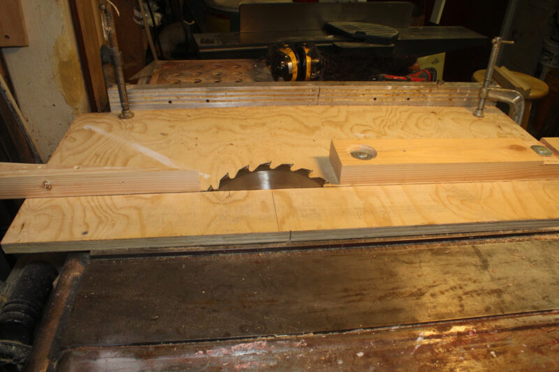 A table saw with straight infeed and wedged outfeed.