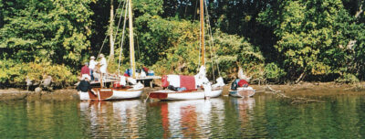 Small wooden sailboats near a beach on the Wye River.