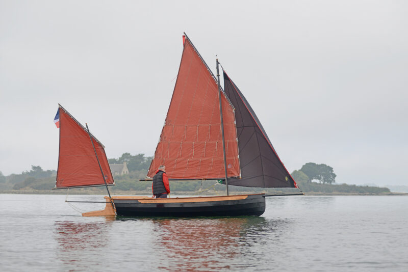 Grand Silmaril with balance lug, mizzen, and genoa, sailing in near calm.