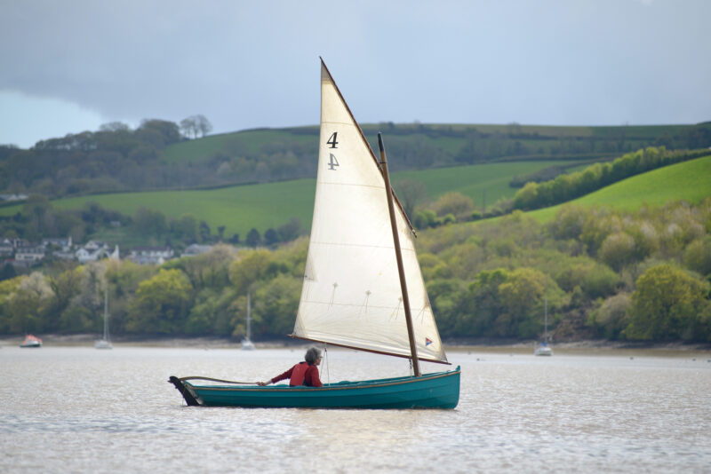Western Skiff under sail on a calm day.