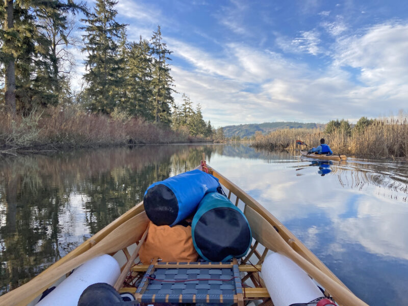Kayak paddling down Elochoman Slough on Columbia River.