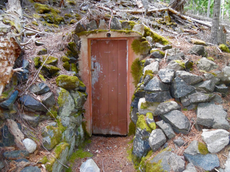 Root cellar door built into rocky hillside on Bartoo Island, Priest Lake, Idaho.