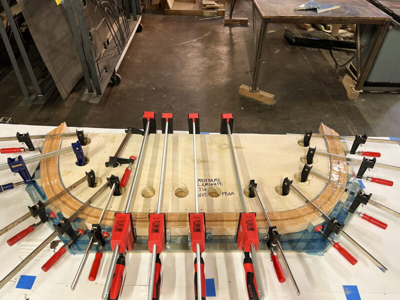 Laminated frame clamped in place on a jig.