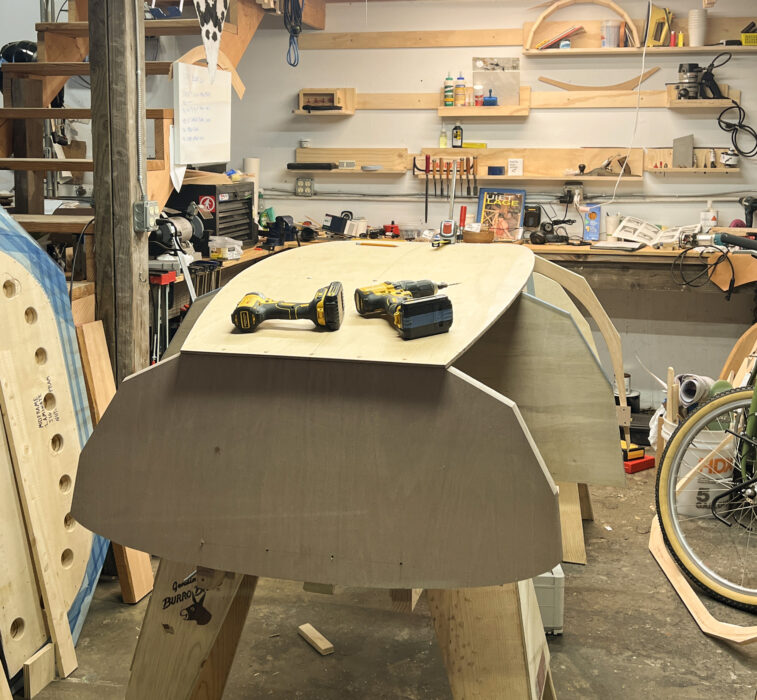 Upturned wooden hull under construction.
