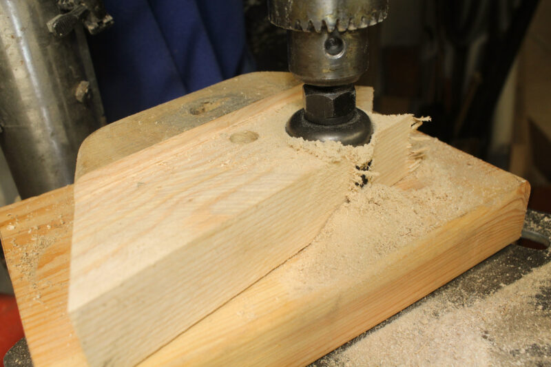 Cutting a wooden plug with a holesaw.