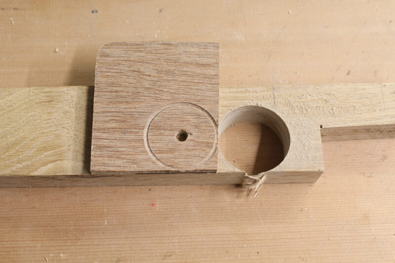 Using a jig to position a holesaw for plug cutting.