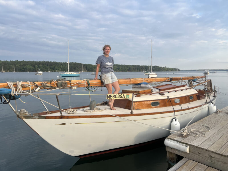 Young woman on foredeck of Gulf Stream 30 with mast unstepped.