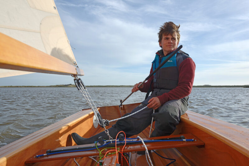 Cockpit and helmsperson on Windsong dinghy.