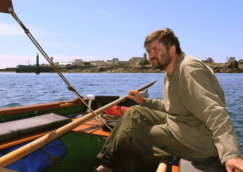 Roger Barnes at the helm of AVEL DRO off the coast of the Île de Sein.