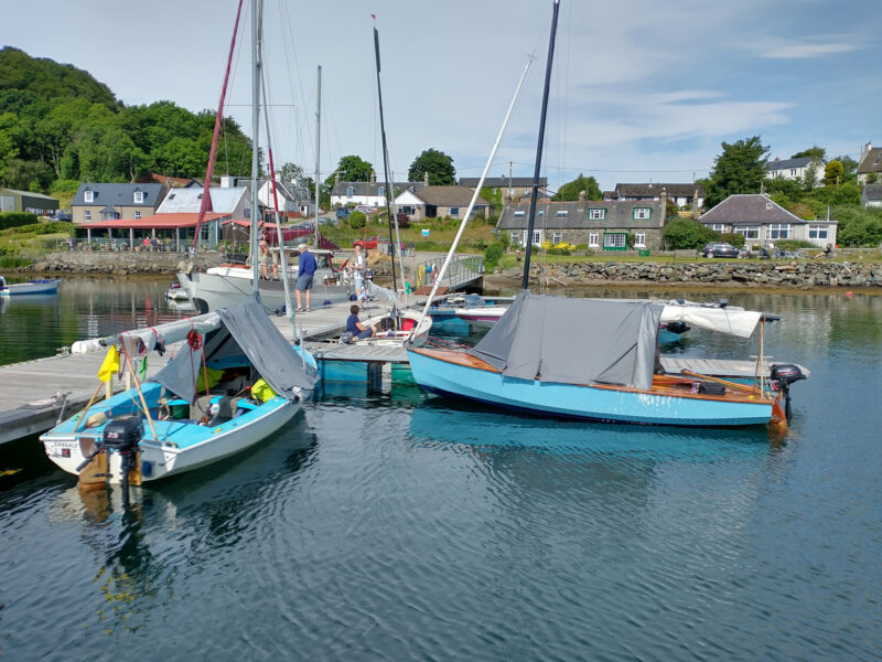Docked Wayfarer sailing dinghies with boom tents.