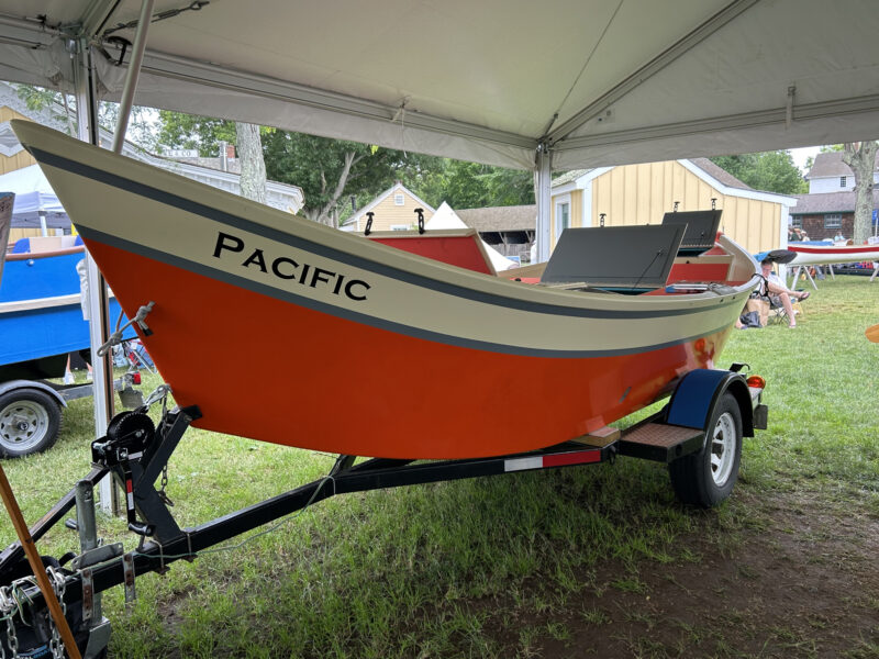 Red-and-white-painted Whitewater dory on trailer.